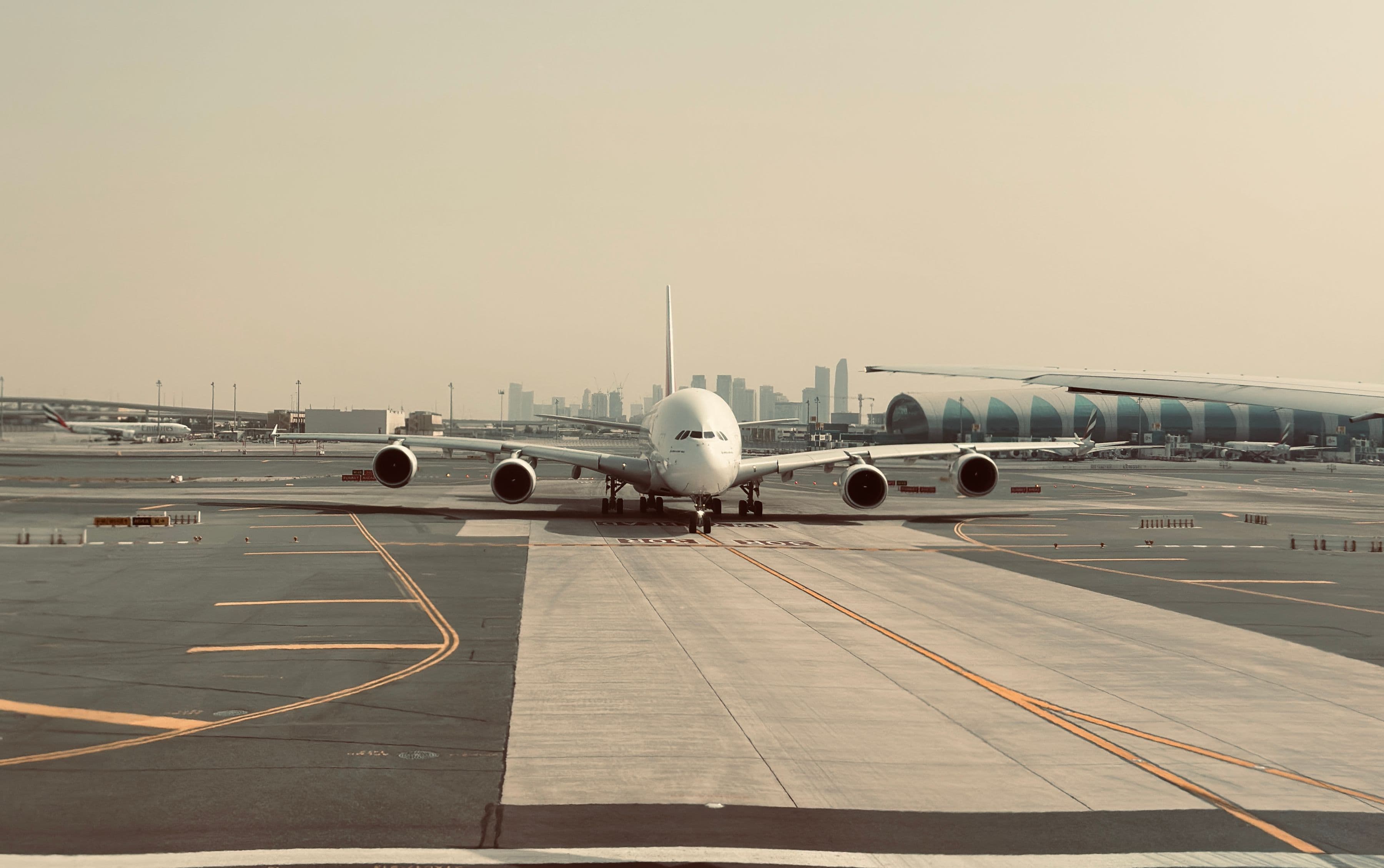 Commercial aircraft on the tarmac at a Dubai airport, representing the city's aviation expansion driving Dubai South real estate demand