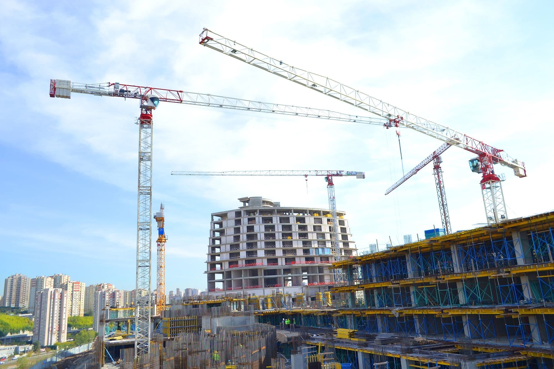 Construction cranes over new Dubai towers, where off-plan property is bought before completion